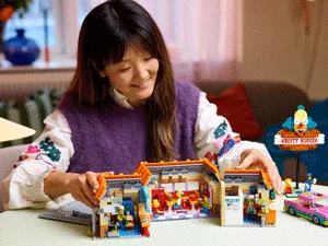 Adult building LEGO Simpsons
