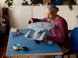 Adult building LEGO Enterprise